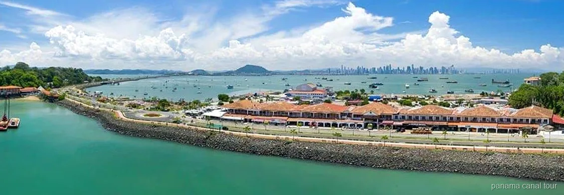 Small group at the Amador Causeway sign on a Panama Canal and skyline tour