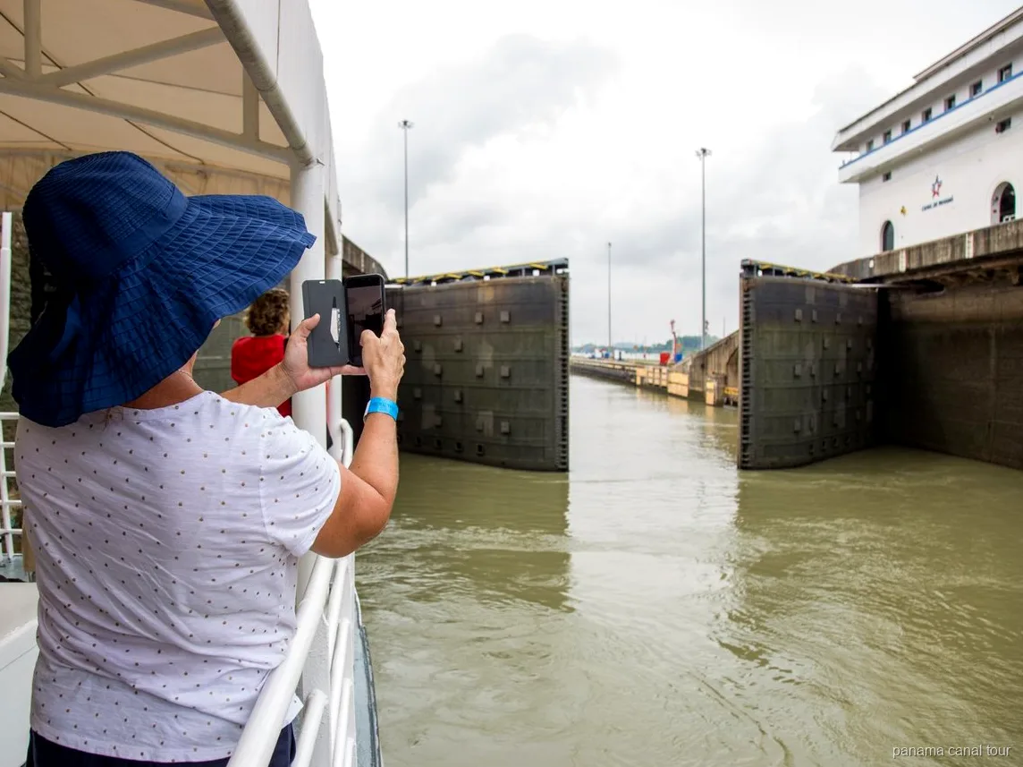 Panama Canal lock chamber filling with water during a full transit tour